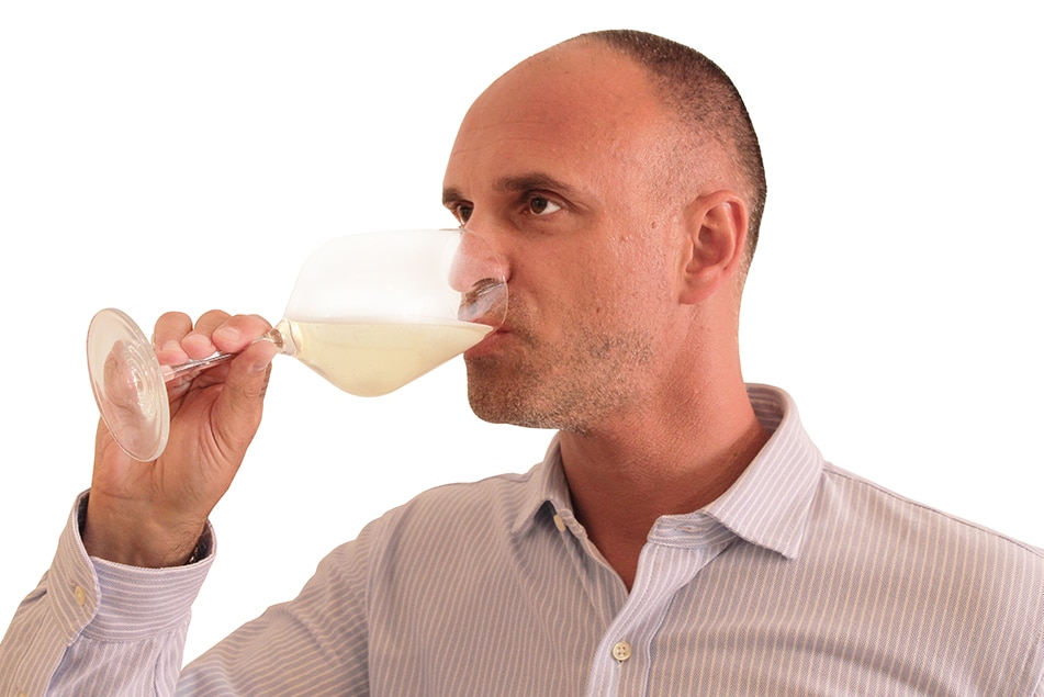 Wine maker tasting white wine
